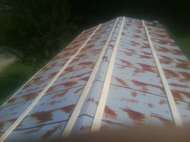 Rusted metal roof panels with new wood purlins before replacement — Storm Damage Roof Repair in Ingomar by Roofing Brothers